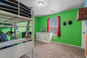 Bedroom featuring visible vents, baseboards, and carpet flooring