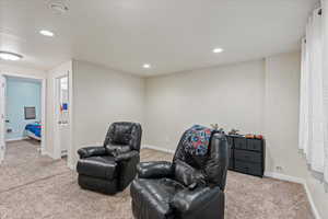 Living area featuring recessed lighting, carpet, and baseboards