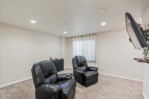 Sitting room with recessed lighting, baseboards, and carpet floors