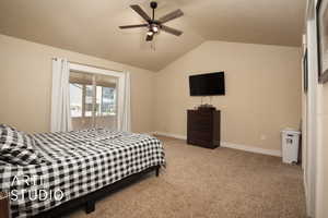 Primary bedroom with vaulted ceilings, ceiling fan, walk in closet, attached bathroom and access to sunroom.