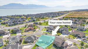 Drone / aerial view with a water and mountain view and a residential view