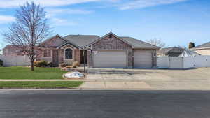 Ranch-style home with fence, brick siding, a gate, and an attached garage