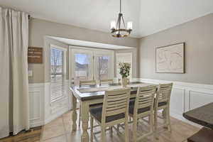 Tiled dining room with an inviting chandelier