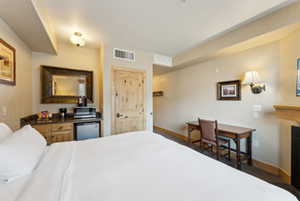 Bedroom featuring a fireplace, visible vents, and baseboards