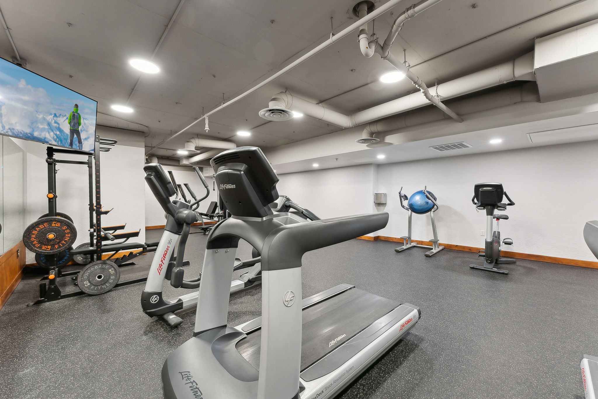 Fitness room featuring resilient flooring, recessed lighting, and a variety of exercise equipment