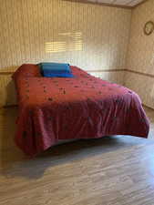 Bedroom featuring wood finished floors and wallpapered walls