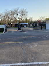 View of street with street lighting and a gated entry