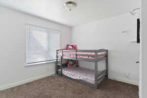 Bedroom with carpet flooring and baseboards