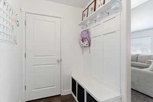 Mudroom featuring dark wood-style flooring