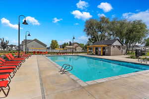 Pool with a residential view, a patio area, and fence
