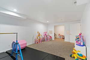 Playroom with baseboards, carpet, visible vents, and recessed lighting