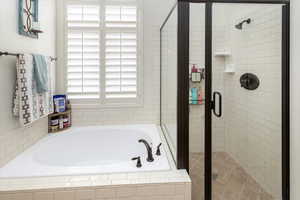 Full bathroom featuring a stall shower and a garden tub
