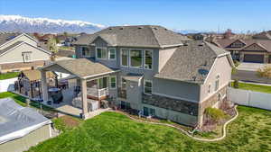 Rear view of property featuring a patio, a fenced backyard, stucco siding, and a residential view