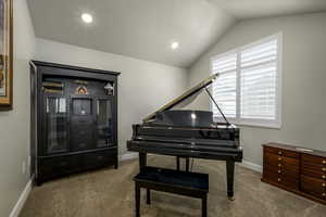 Living area with baseboards, recessed lighting, carpet flooring, and lofted ceiling