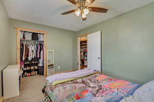 Bedroom featuring a closet, a ceiling fan, and carpet floors