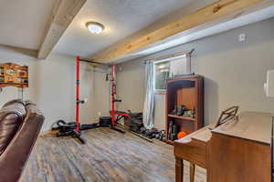 Workout room featuring wood finished floors