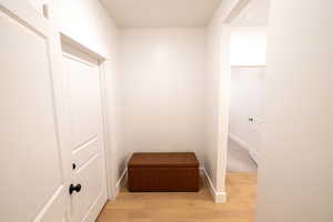 Interior space with baseboards and wood finished floors
