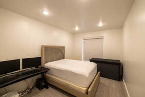 Bedroom featuring baseboards, recessed lighting, and carpet
