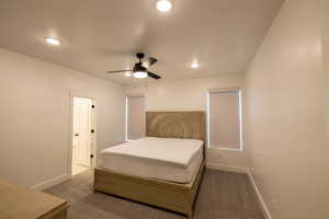 Carpeted bedroom with recessed lighting, baseboards, connected bathroom, and ceiling fan