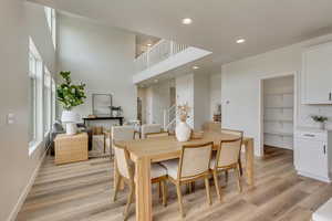 PHOTOS FROM SIMILAR HOME. OPTIONS AND FINISHES WILL VARY. Dining room featuring recessed lighting, light wood finished floors, and a healthy amount of sunlight