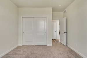 PHOTOS FROM SIMILAR HOME. OPTIONS AND FINISHES WILL VARY. Guest room (bedroom 5) bedroom with carpet flooring, visible vents, a closet, and baseboards