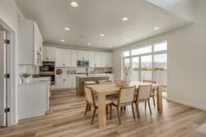 PHOTOS FROM SIMILAR HOME. OPTIONS AND FINISHES WILL VARY. Dining room with visible vents, light wood-style flooring, recessed lighting, and baseboards