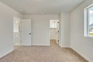 PHOTOS FROM SIMILAR HOME. OPTIONS AND FINISHES WILL VARY. Bedroom 2 featuring visible vents, a spacious closet, carpet, and baseboards