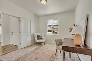 PHOTOS FROM SIMILAR HOME. OPTIONS AND FINISHES WILL VARY. Office area with visible vents, baseboards, and wood finished floors