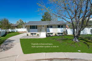 View of front of home featuring a front lawn and fence