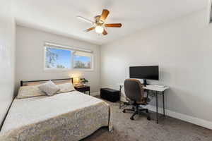 Bedroom with baseboards, a ceiling fan, and carpet flooring