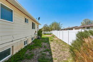 View of yard with a fenced backyard and cooling unit