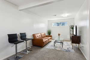 Carpeted living room featuring baseboards and visible vents