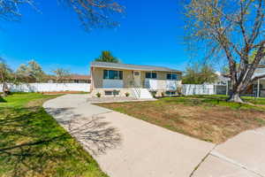 Bungalow-style home with a front yard and fence