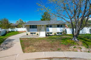 View of front of property featuring a front yard and fence