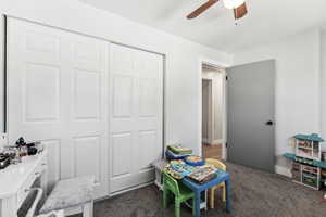 Game room with ceiling fan, baseboards, and carpet floors