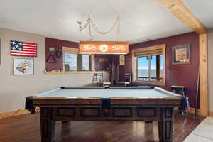 Recreation room with  beamed ceiling, and pool table