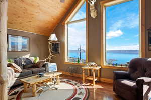 Living area with hardwood, wood floors, lofted ceiling, a Bear Lake view, and wood ceiling