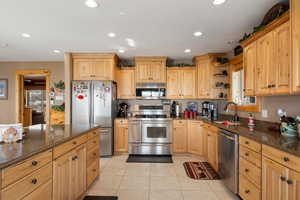 Kitchen with granite  countertops, appliances with stainless steel finishes