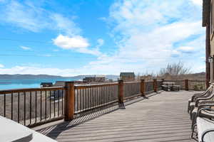 Deck with a water and mountain view