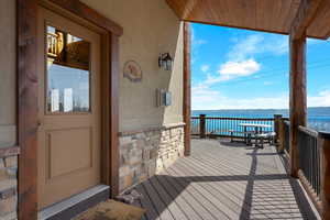 Deck featuring a lake view and main entry