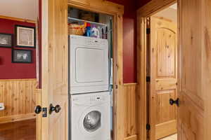 Laundry area with  stacked washer and dryer