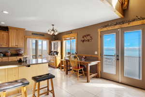 Kitchen with  a breakfast bar, recessed lighting, french doors, and tile flooring