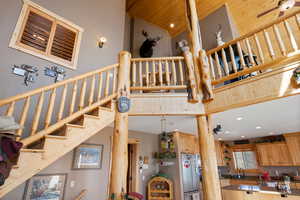 Staircase featuring a high ceiling, and wood ceiling
