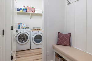 Washroom featuring independent washer and dryer, laundry area, and light wood-type flooring