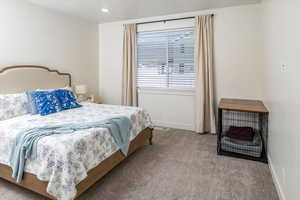 Bedroom with carpet flooring, baseboards, and visible vents