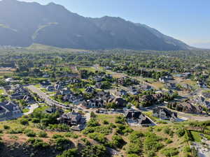 View of mountain backdrop featuring nearby suburban area