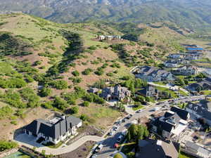 Aerial overview of property's location with a mountainous background and nearby suburban area