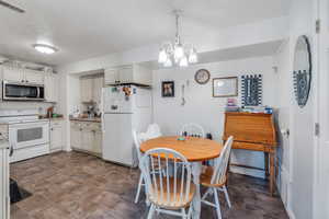 Dining area with a chandelier and visible vents