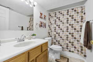 Full bath featuring visible vents, a shower with curtain, toilet, vanity, and tile patterned flooring