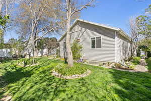 View of property exterior with a lawn